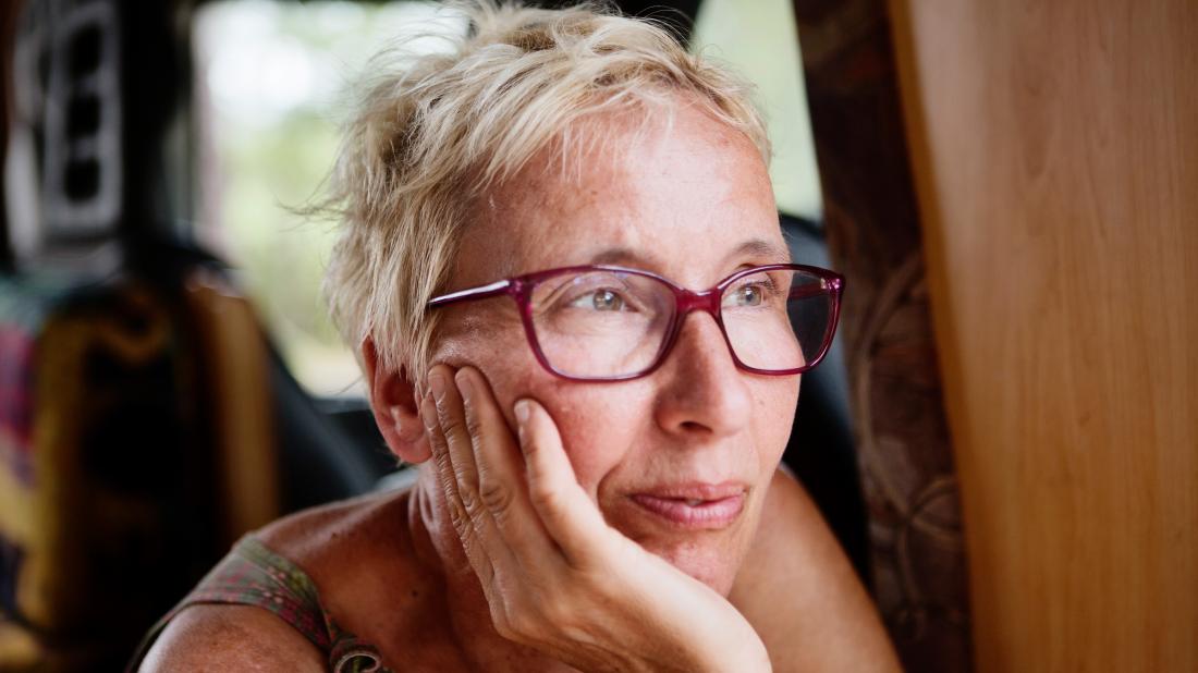 a woman looking pensive as she thinks about when she will go through the menopause